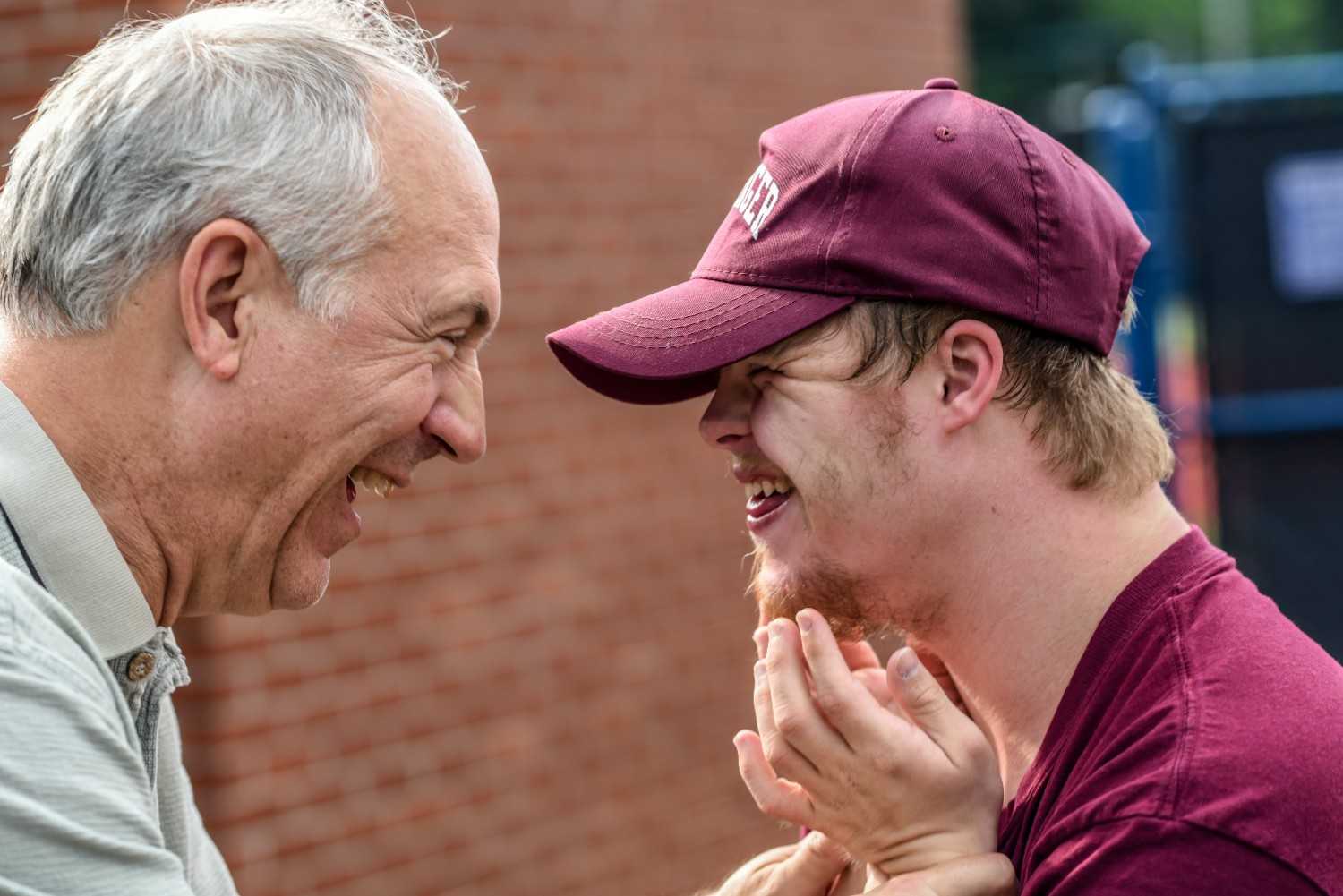 man with autism having fun with grandfather